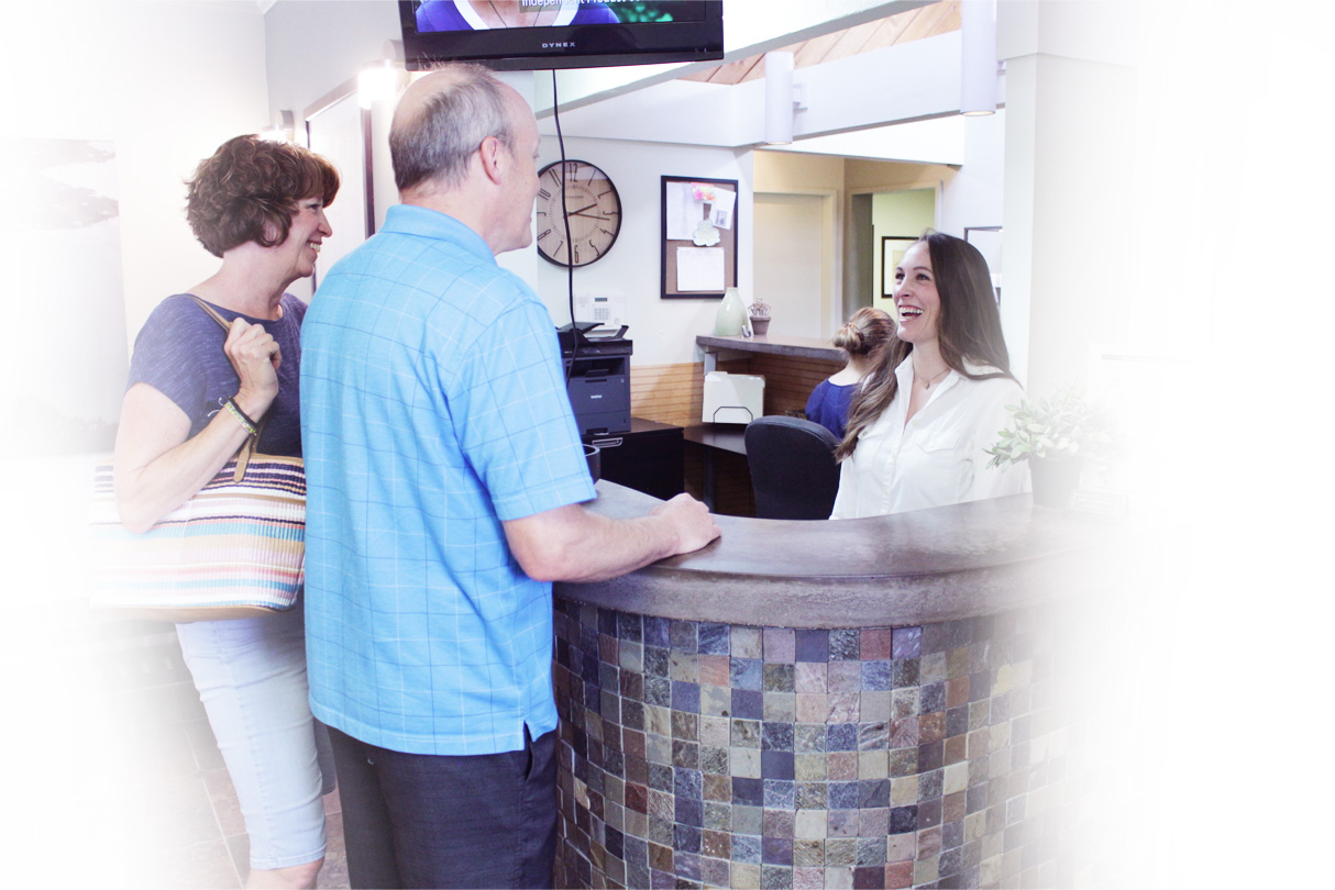 Staff welcoming patients at front desk