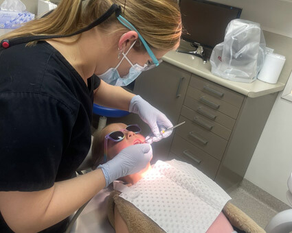 Dentist treating little girl at Smile Central