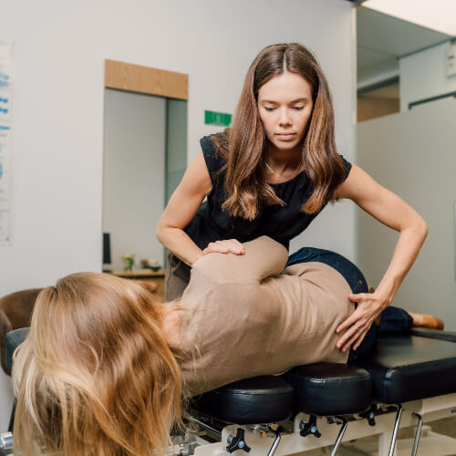 Chiropractor adjusting a female patient
