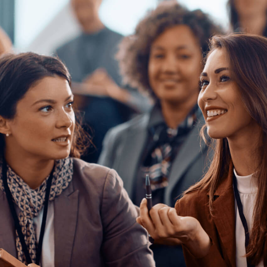 people talking to one another and smiling