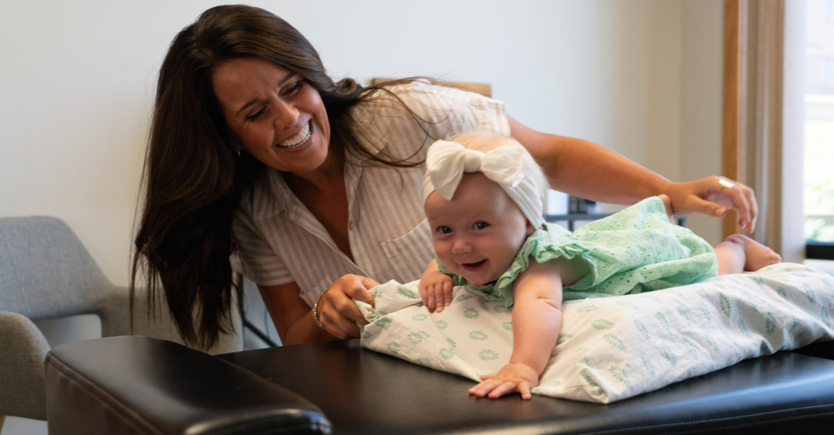 Dr Maggie with smiling baby girl