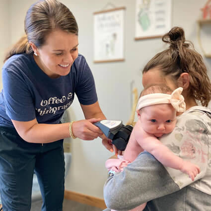 Dr. Maggie scanning infant