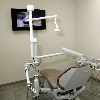 Dentist working on patient in chair