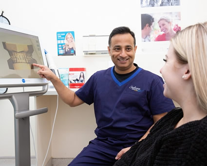 Dentist reviewing xrays with patient