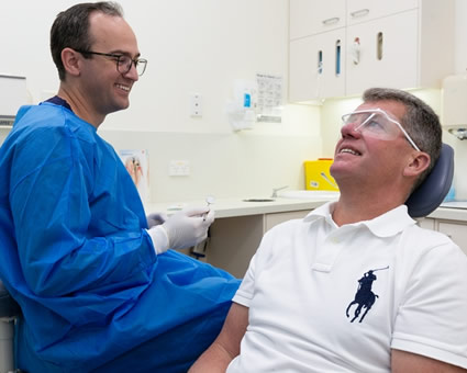 Dentist with male patient