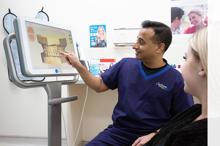 dentist pointing at computer screen