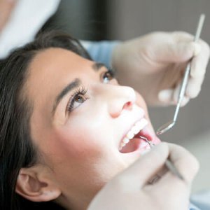 Woman having teeth cleaned