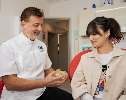 Hurstville dentist Dr. George in consultation with patient