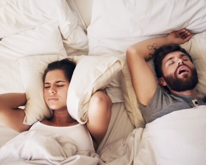 Wife struggling to sleep, husband snoring