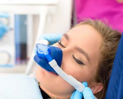 Woman getting sedation in dental chair