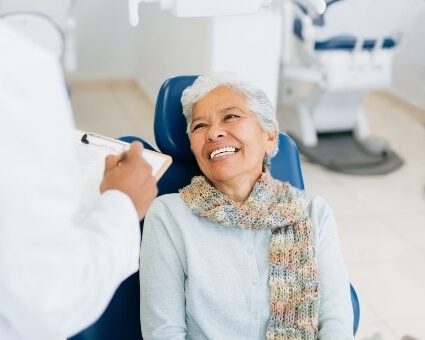 Elderly lady smiling in dental chair