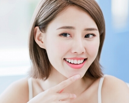 Woman pointing at beautiful smile