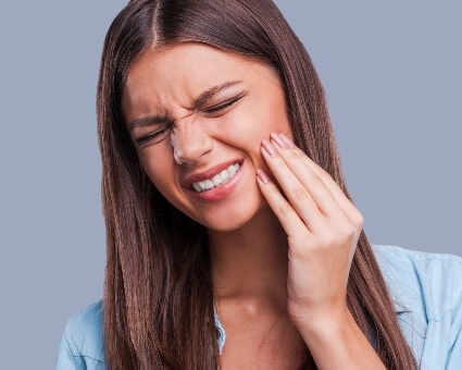 Young woman with jaw pain