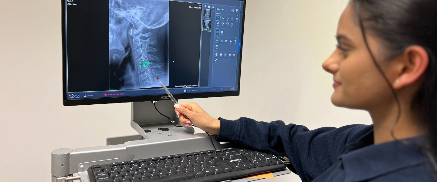 Chiropractor pointing x-ray