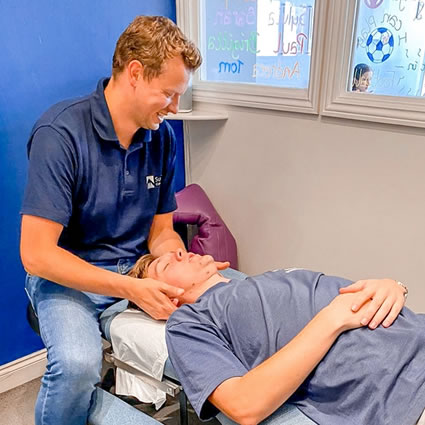 Doctor adjusting mans neck