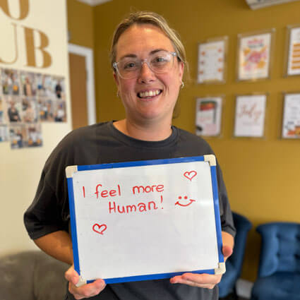 Woman holding feel human sign