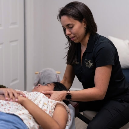 Dr Liz adjusting patients neck