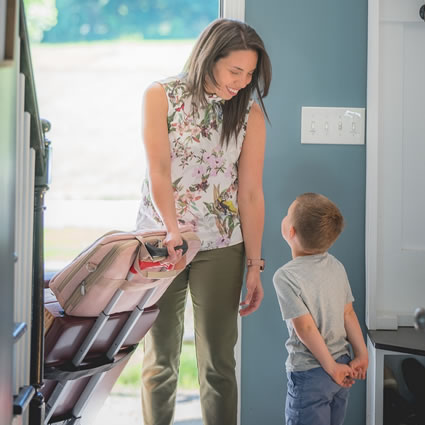 Boy greeting Dr Liz at door