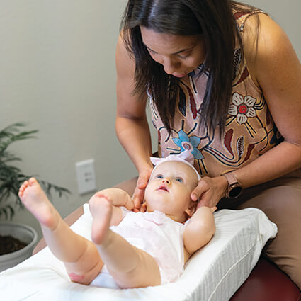 Mojica Chiropractic Care Doctor adjusting baby