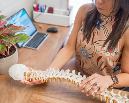 Dr. Liz holding spine model