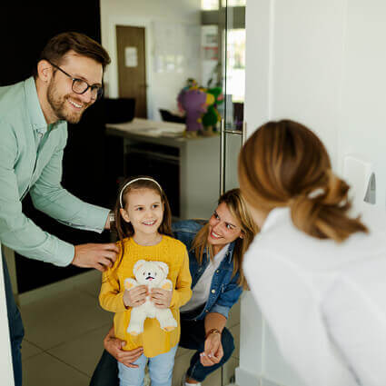 family-with-daughter-greeting-dentist-sq