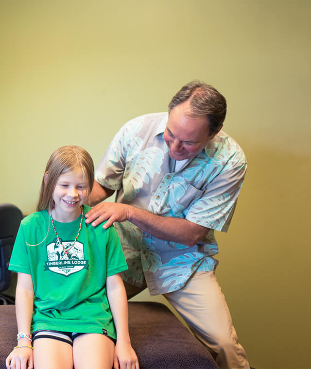 Dr. Scott with girl sitting