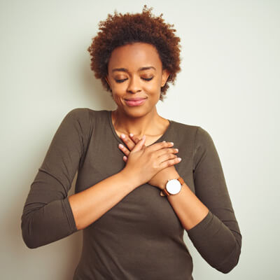 grateful woman with her hands on her heart