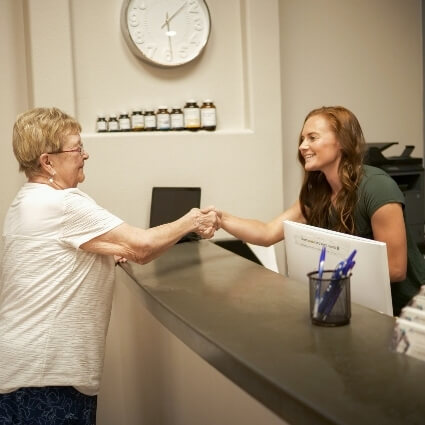 Receptionist greeting female patient