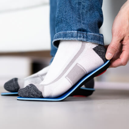 Man fitting orthotics
