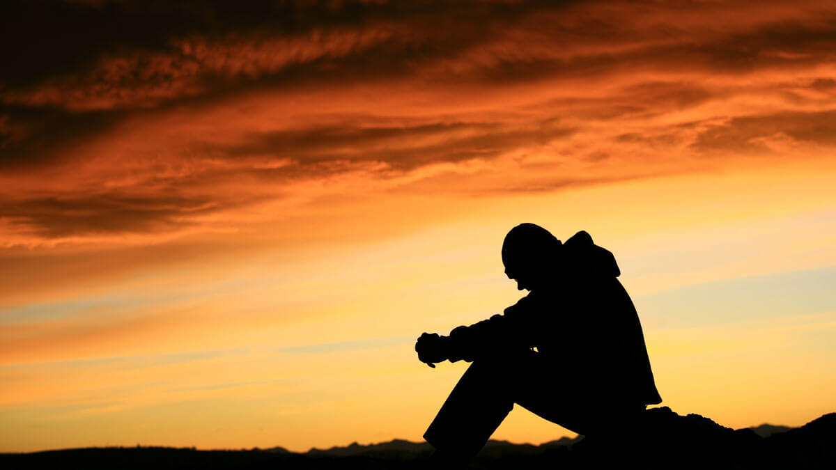 Man thinking at sunset
