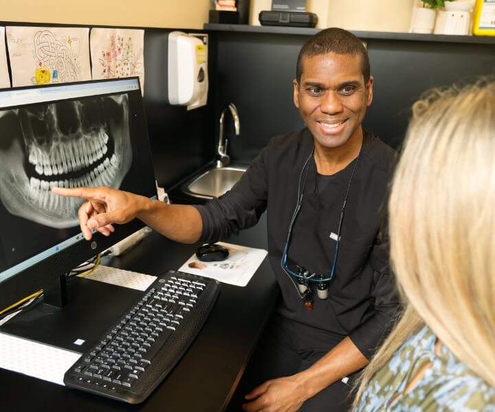 dentist showing x-ray to patient