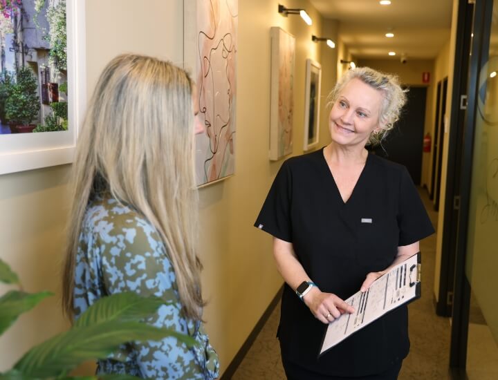 staff showing form to patient