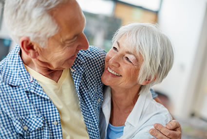 Couple hugs smiling at each other