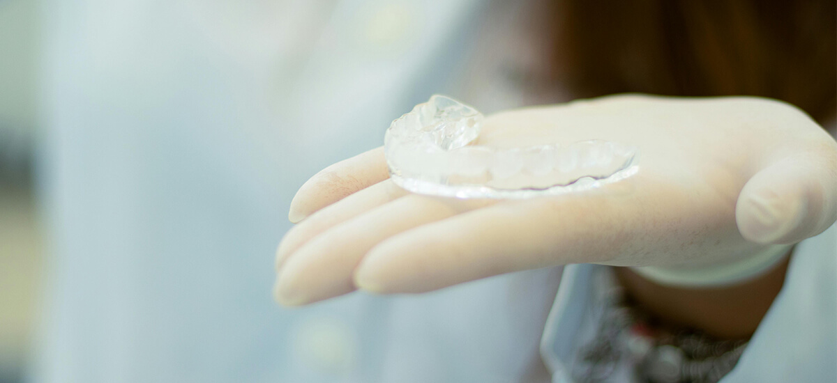 person holding custom mouthguard