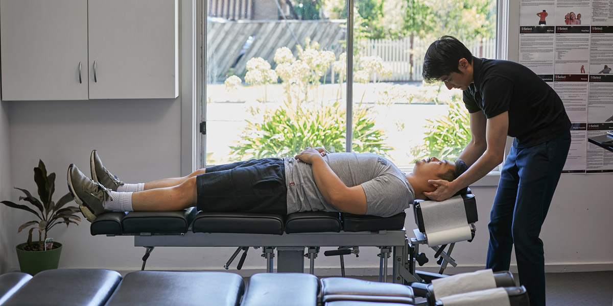 Dr Thong Phan adjusting patient's neck