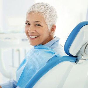 woman turned backward in dental chair