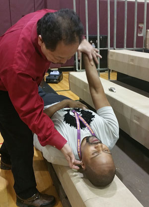 Dr. Mariano adjusting a basketball player