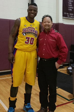 Dr. Mariano with basketball player