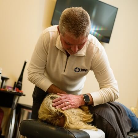 Dr Hoover adjusting patients head