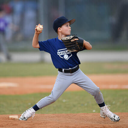 boy-in-blue-jersey-pitching-baseball-sq
