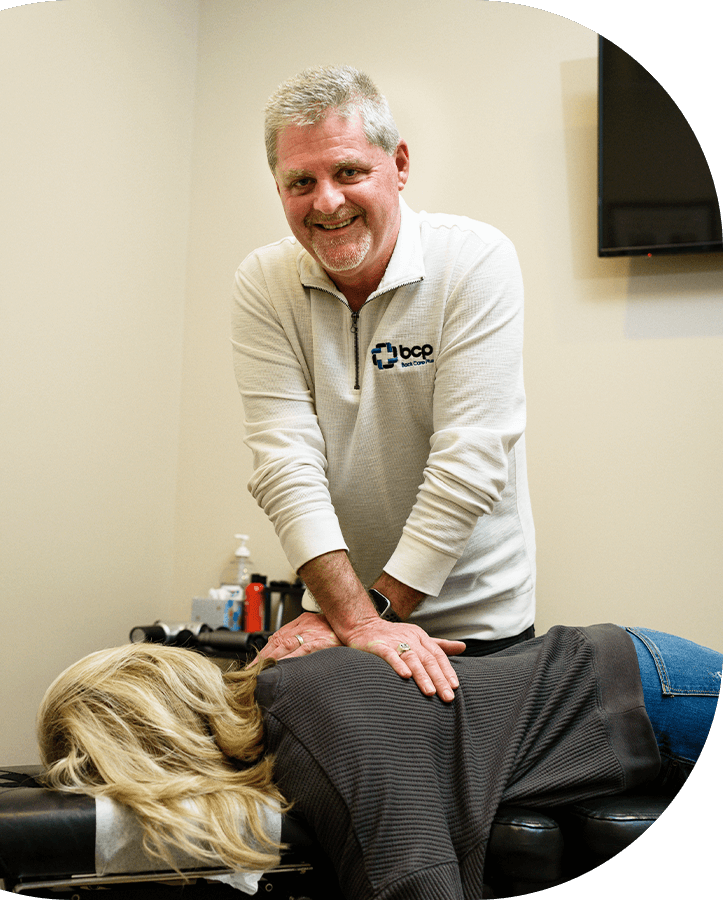 Chiropractor adjusting patient