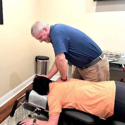 Dr. Hoover adjusting patient's shoulder