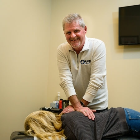 Dr Hoover adjusting patients back