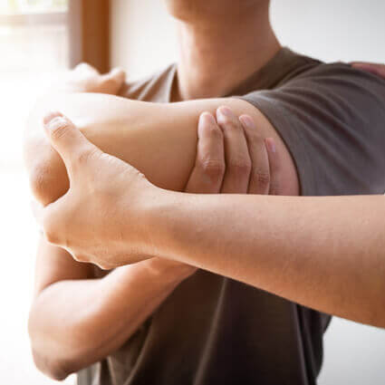 man-in-grey-tshirt-having-elbow-examined-sq
