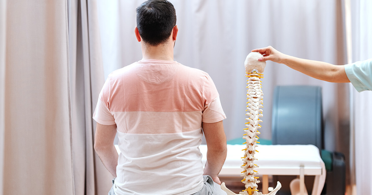Man sitting next to spine