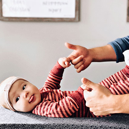 parent holding babys hands