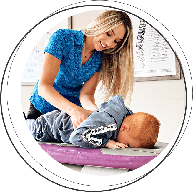 Blue Wing Chiropractic, LLC's Dr. Kendra adjusting young boy