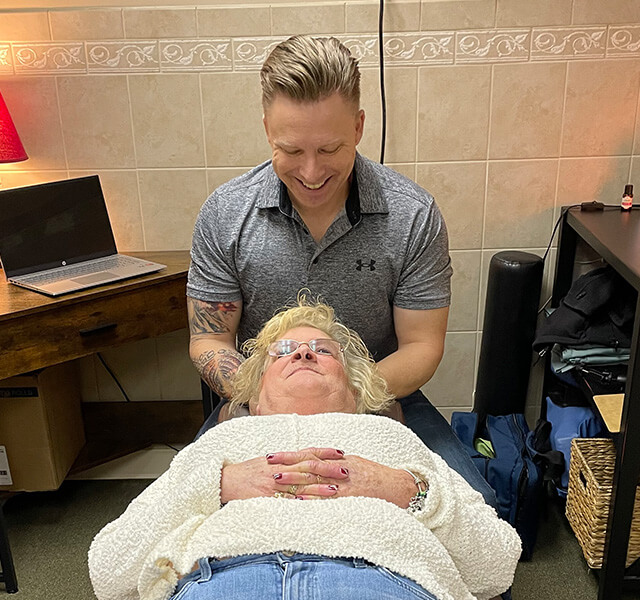 Dr. Gibson massaging patients head