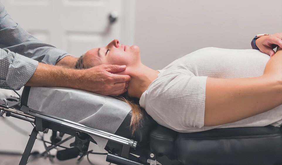 Female patient receiving an upper-cranial adjustment