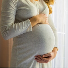 Pregnant woman holding her stomach